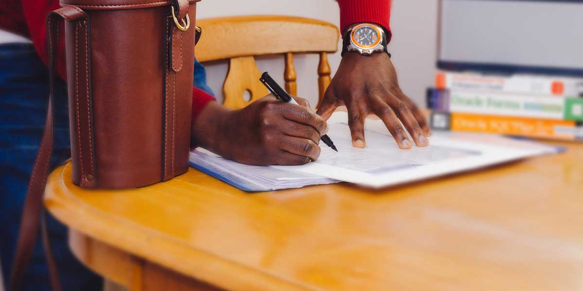 man signing paper